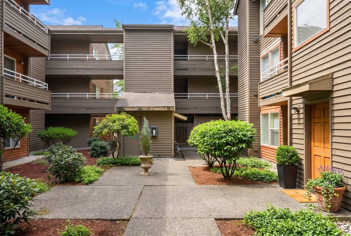 Westwood Court Seattle apartment living room for rent; bright space with large windows and modern finishes.